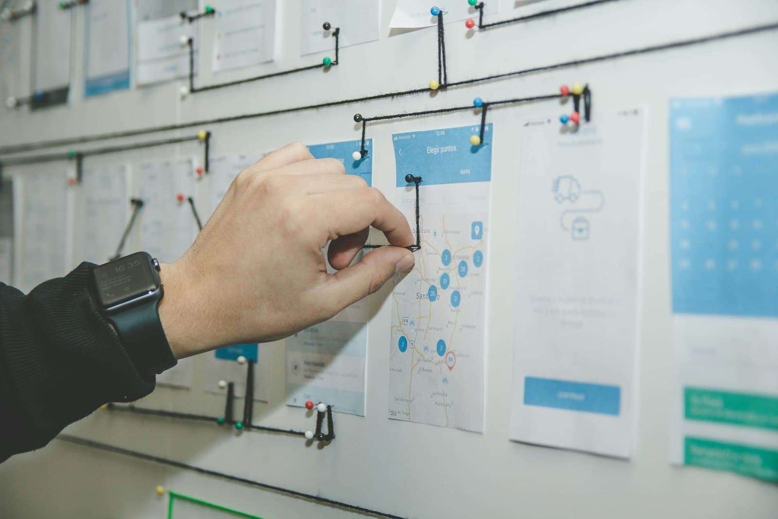 Planning notes and interface sketches spread across a desk